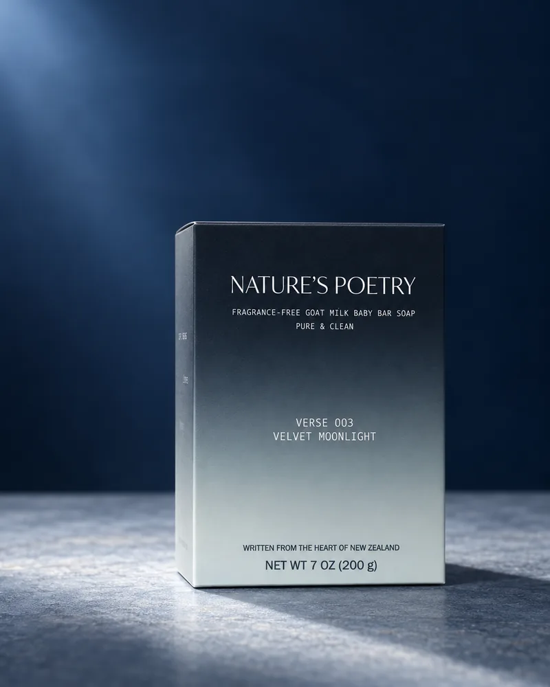 The Verse 003 Velvet Moonlight carton, navy fading to mint, lit like moonlight on grey stone.